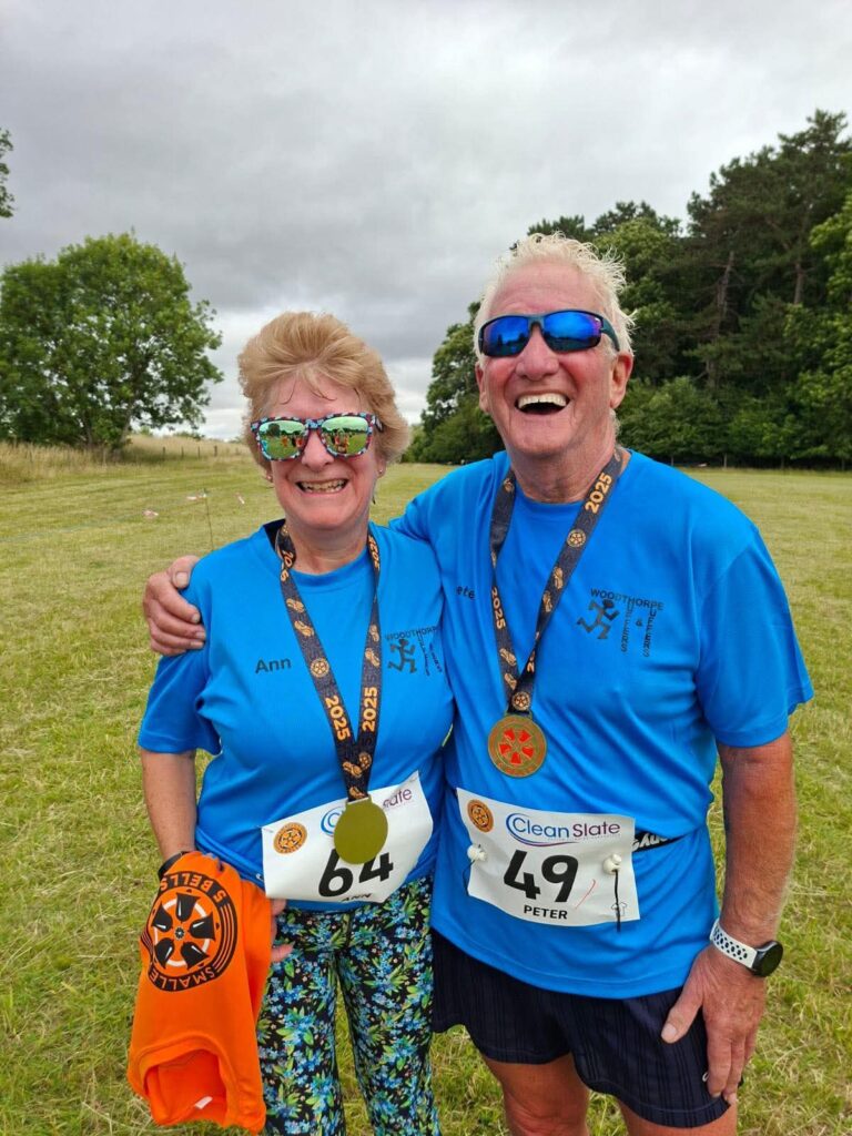 two runners at the end of a running event, with medals