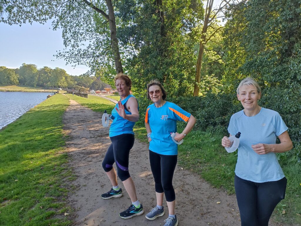 Three runners on a track in the countryside